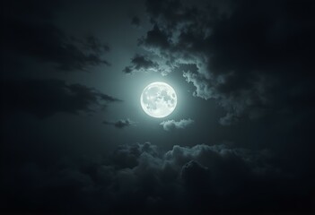 Fototapeta premium Night sky with moon light. Dramatic clouds in mystic moonlight. Large bright moon as concept of mystery, midnight, gothic time and spooky theme. Moody sky texture background.