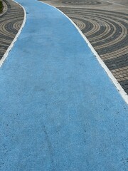 Fototapeta premium Blue Walking Path with Circular Stone Paved Plaza in the Center