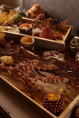 Cozy autumn decor with candles, pinecones, and berries, creating a rustic, seasonal ambiance perfect for fall.