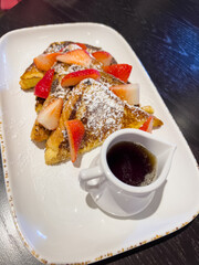 Decadent French Toast with Strawberries and Syrup at Hotel Breakfast