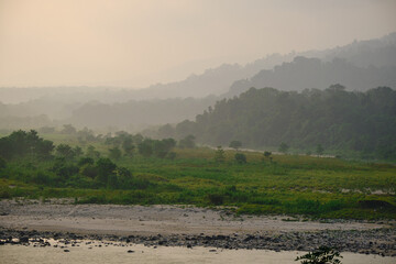 The Beki river flows past the wooded hills through a  valley in Manas National Park in Assam, India
