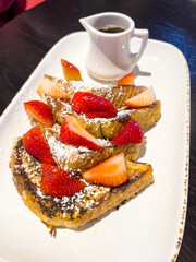 Decadent French Toast with Strawberries and Syrup at Hotel Breakfast