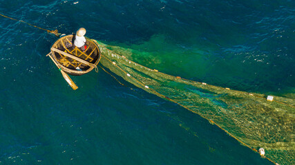 Fishermen spread nets to catch fish at Chan May beach, Hue, in the middle of the vast sea and the...