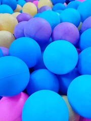 Background with a close-up of colorful plastic balls in a playroom 