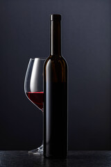 Bottle and glass of red wine.