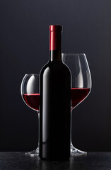 Bottle and glasses of red wine.