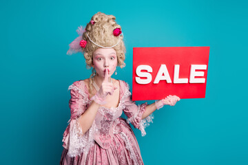 Portrait of young princess girl shh gesture sale poster wear vintage dress isolated on turquoise...