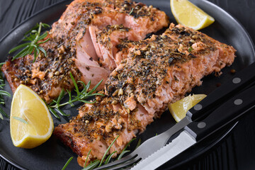 baked salmon fillet with lemon, rosemary on plate
