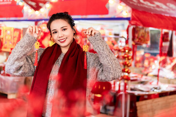 A young woman strolls through the flower street during Chinese New Year