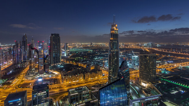 Dubai International Financial Centre district with modern skyscrapers night to day timelapse