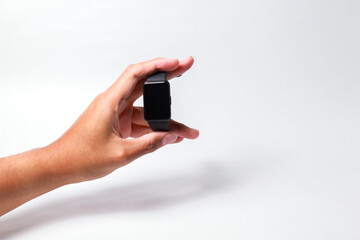 Male hand holding smart watch on isolated background