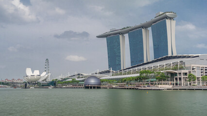 Naklejka premium Fifty-five storeys high Marina Bay Sands Hotel dominates the skyline at Marina Bay in Singapore timelapse hyperlapse.