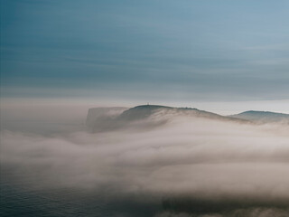 Fog and clouds over the mountains of the island in the sea