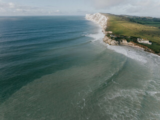 Aerial view of an island in the sea and sea waves