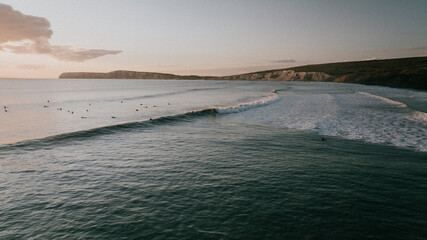 Fototapeta premium Aerial view of waves and a coastal island in evening