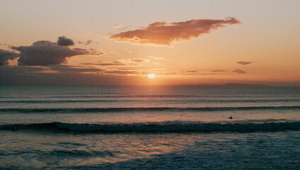 Sunset view in the sea and shallow waves near the beach at evening