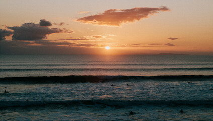 Sunset view in the sea and shallow waves near the beach