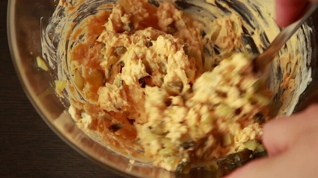 Mixing Hard-Boiled Egg Yolks with Chopped Pickles to Make Deviled Eggs - Close-Up