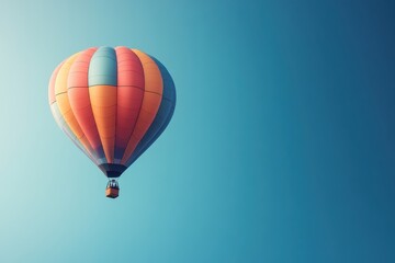 Obraz premium Colorful Hot Air Balloon Floating in a Clear Sky, Representation of Adventure, Freedom, and Joy, Perfect for Travel and Outdoor Themes