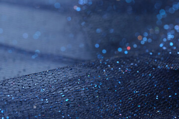 Blue tulle fabric with sparkling glitter. Christmas concept background. Close up macro