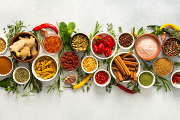 A collection of various spices and herbs on a gray background, perfect for enhancing dishes with...