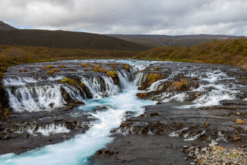 Wide Waterfall in Iceland with Blue Water