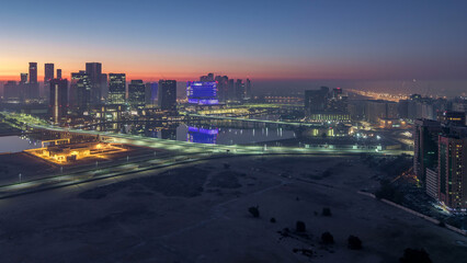 Abu Dhabi city skyline with skyscrapers before sunrise from above night to day timelapse