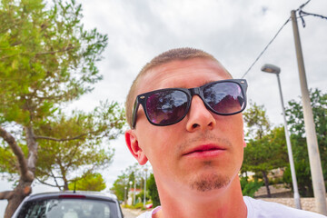 Cool man with sunglasses in the city in Croatia.