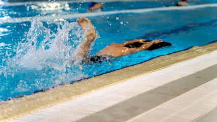 boy athlete in the pool with a coach