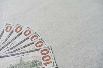 portrait of neatly arranged 100 US dollar bills, currency concept, isolated on grey background.
