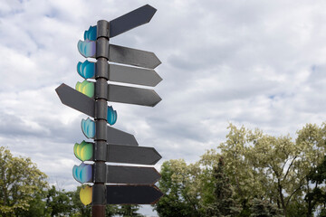 Several empty signs with direction indicators against a cloudy sky. Place for text. horizontal....