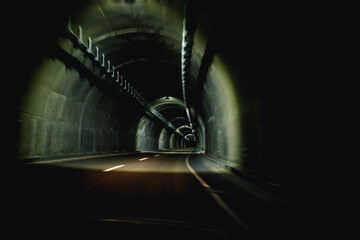 Winding Road Through a Dimly Lit Tunnel