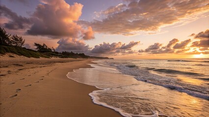Sunset over a calm beach with golden light reflecting on water, soft clouds in the sky