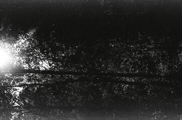 The sunlight peeks through the trees in a black and white photograph