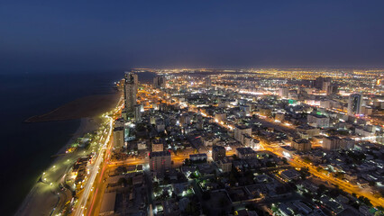 Cityscape of Ajman from rooftop day to night aerial timelapse