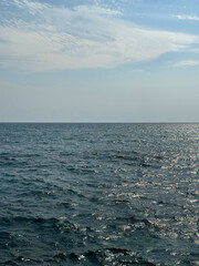 Blue sparkling sea waves and sky.