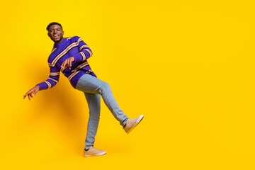 Full size photo of nice young man dance empty space advert isolated on yellow color background