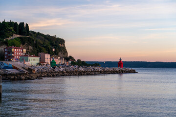 Piran, Slovenia - November 3, 2024: Red lighthouse against the sea.