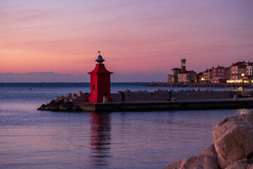 Piran, Slovenia - November 3, 2024: Red lighthouse against the sea.