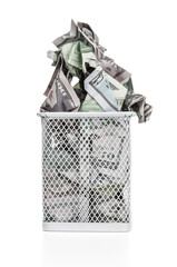 Crumpled dollar banknotes in trash basket on a white background