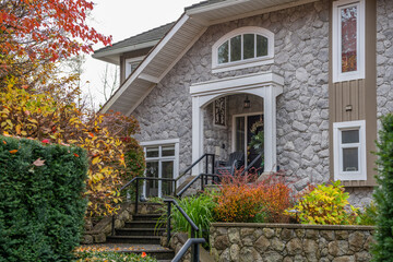 Fragment of  luxury house in fall with green trees and nice landscape in Vancouver, Canada, North America. Day time on November 2024.