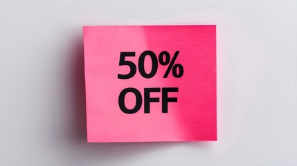 Black '50% OFF' Text on a Pink Square Paper Note. White Background with Copy Space