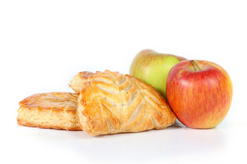 French apple turnovers with two whole apples on a white background