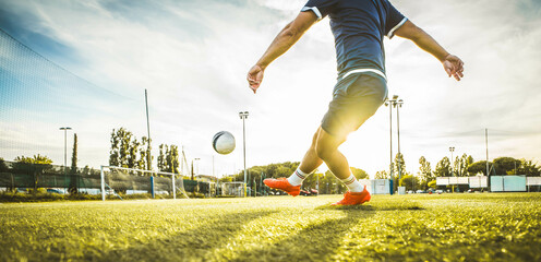 Professional football kicking ball in soccer stadium - Athletic man training sport outside - Concept about sports, competition, motion, overcoming