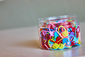 Colorful Knitting Stitch Markers in Clear Jar Eye-Level View