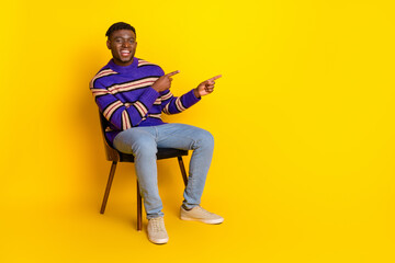 Full size photo of nice young man direct fingers empty space isolated on yellow color background