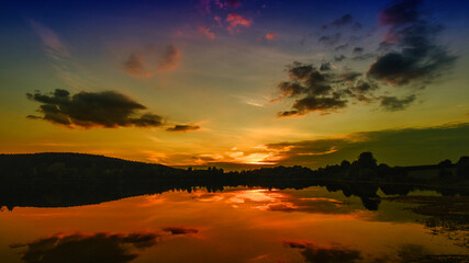 lake at sunset in the clouds