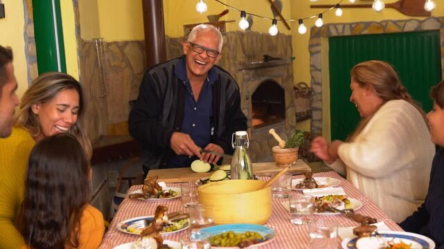 Multi generational latin family cooking barbecue dinner at house terrace during autumn season - Winter season, love and food concept 