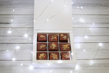 chocolat candies packed in a white box near glowing lights