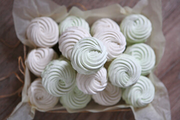 vanilla marshmallows stacked high on parchment paper and tied with string 